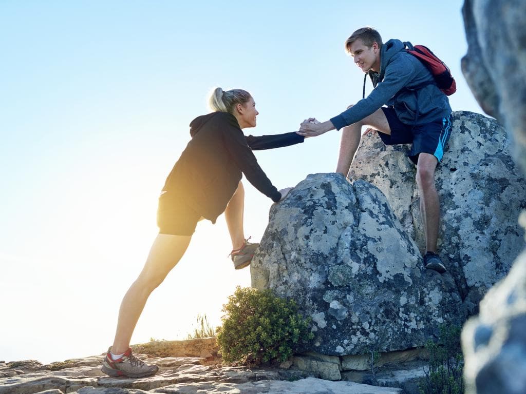 Man and woman climbing header L